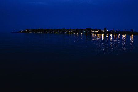 City lights reflected in the water at night thumbnail