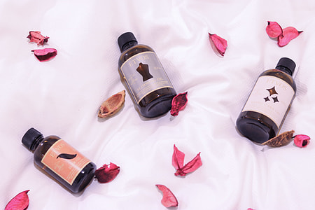 three glass bottles place on white textile thumbnail