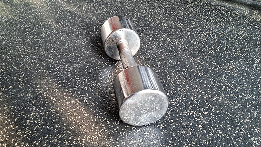 silver fixed-weight dumbbell on table thumbnail