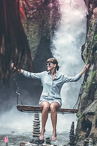 photo of woman on swing with waterfall background thumbnail