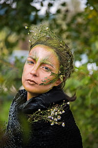 woman wearing green floral headdress and black top selective focus photography thumbnail