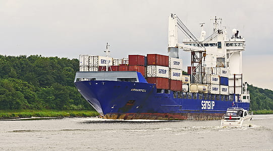 white and blue cargo vessel during daytime thumbnail