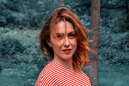 smiling woman in white and red striped top thumbnail