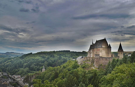 aerial view photography of brown castle near mountain thumbnail