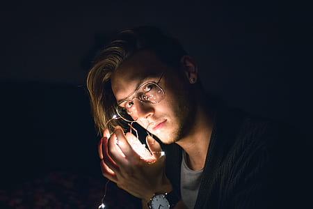 man holding white string lights thumbnail