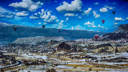 panorama photography six hot air balloons flying above and mountain range view thumbnail
