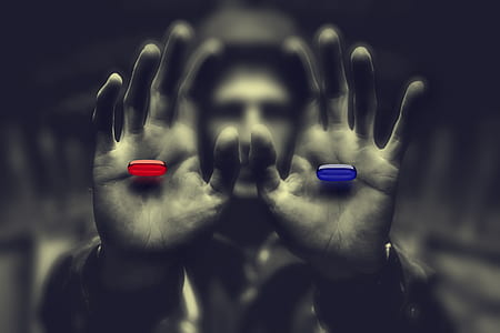 man holding red and blue pills thumbnail