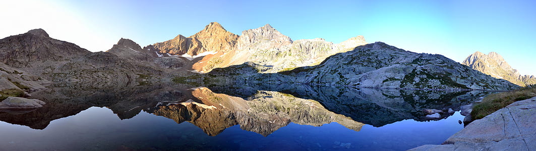 Brown Mountain Near Body of Water during Daytime thumbnail