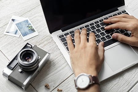 MacBook Pro and gray DSLR camera thumbnail