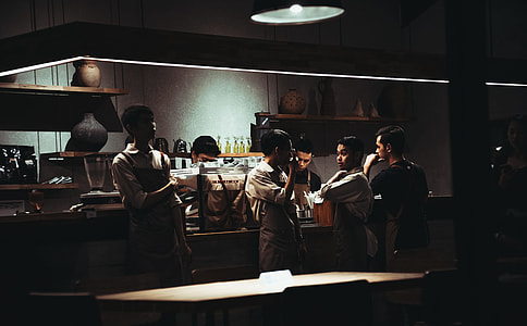 man wearing brown apron in restaurant thumbnail