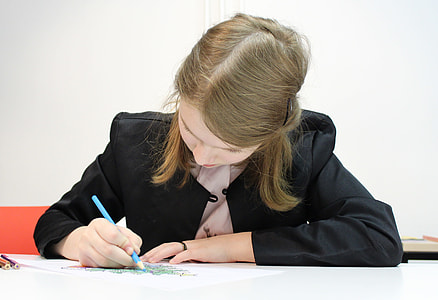 woman wearing black blazer holding blue pen beside table thumbnail
