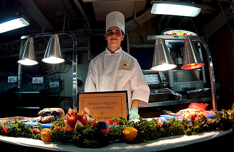 man wearing white chef uniform and teal gloves thumbnail