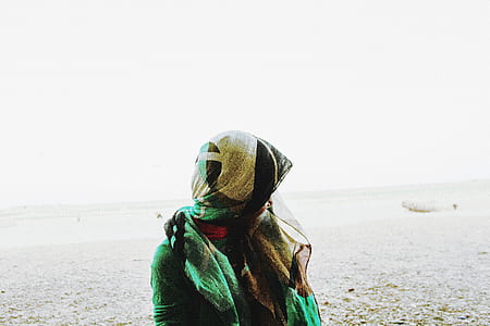 woman wearing green dress walking on sand thumbnail