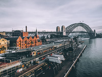 photo of dock near body of water and suspension bridge thumbnail