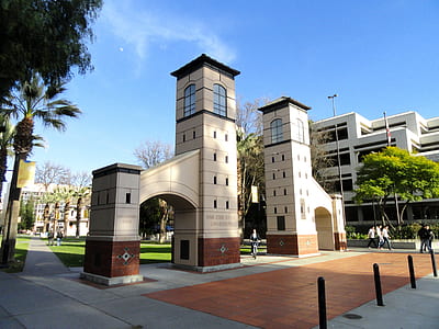 white concrete buildings and trees at daytime thumbnail