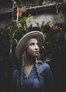 woman standing in front of green plants during daytime thumbnail