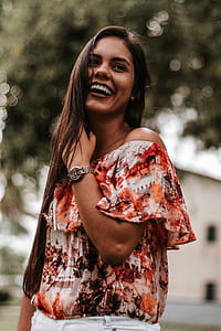 woman laughing while holding her hair thumbnail
