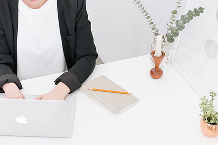 person using MacBook Pro on table thumbnail