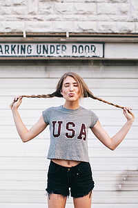 woman wearing gray USA printed cap-sleeved crop top and black short shorts thumbnail