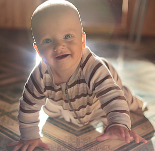 baby in black and grey strip footed sleeper crawling thumbnail