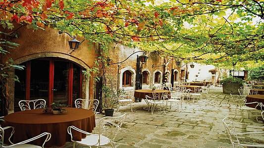 tables and chairs outside the stone building under garden roof thumbnail