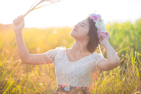 woman wearing white mesh scoop-neck short-sleeved shirt holding wheat leaning up thumbnail