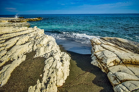 photo of gray mountains near ocean thumbnail