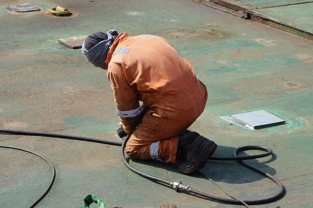 man kneeling on concrete surface thumbnail
