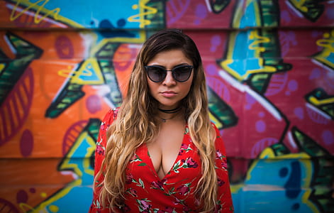 woman standing behind red, blue, and green painted wall thumbnail