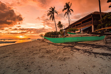 green canoe near seashore thumbnail