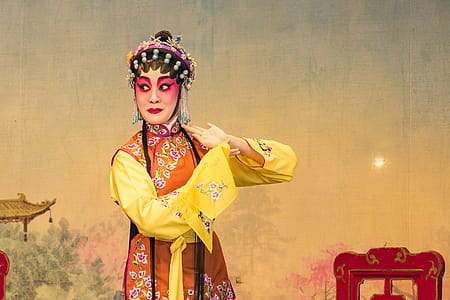Woman in Orange and Yellow Floral Long-sleeved Dress thumbnail
