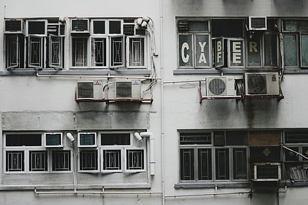 front view of white building with window-type air conditioners thumbnail