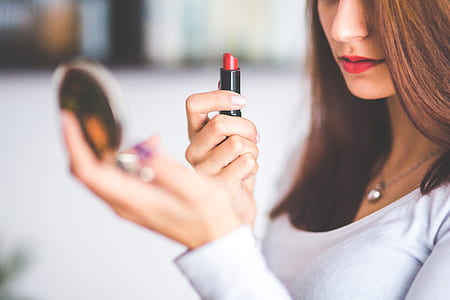woman holding red lipstick thumbnail