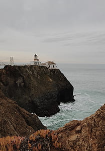 landscape photography of mountains beside seashore thumbnail