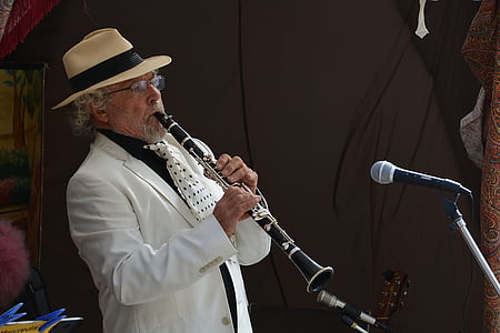 bearded man wearing fedora hat playing flute in front of microphone thumbnail