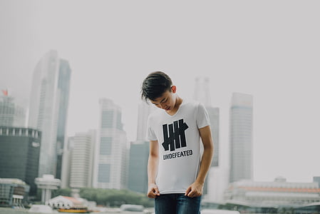 man looking down at camera thumbnail