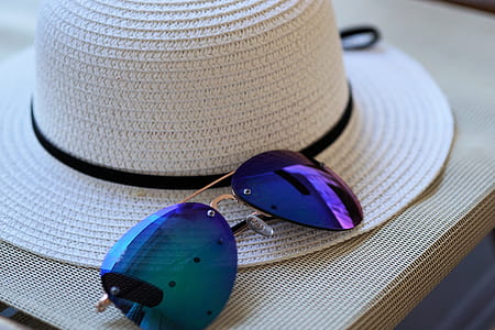 purple sunglasses beside white strawhat thumbnail