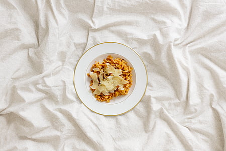 round white ceramic plate with cooked food on white textile thumbnail