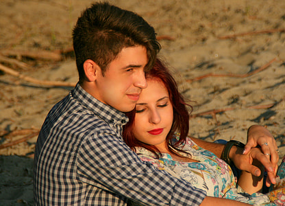 man hugging woman on sand thumbnail