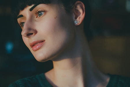 Woman Wearing Silver Earrings and Green Shirt thumbnail