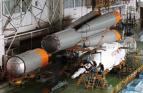 man stepping on step stool near gray and white space shuttle thumbnail