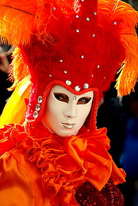 person wearing red feather mask and costume thumbnail