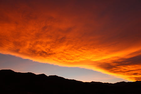 silhouette photo of land under brown sky thumbnail