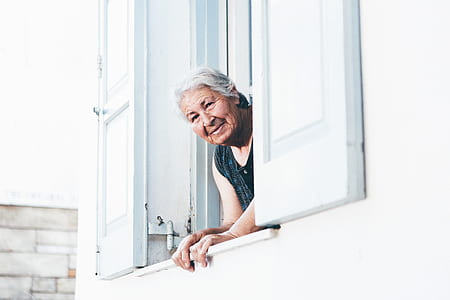 person wearing black top peeking on window thumbnail