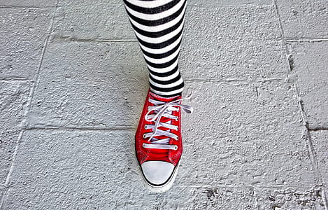 person wearing red low-top sneaker thumbnail