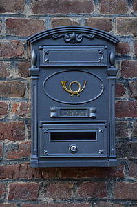 blue metal mailbox mounted on concrete brick wall thumbnail