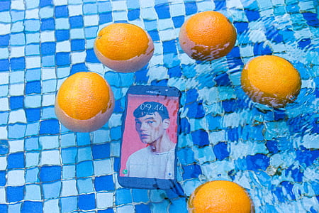 smartphone in body of water under orange fruits thumbnail