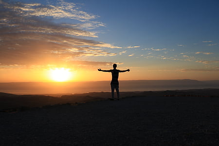 silhouette of person on top of climb thumbnail