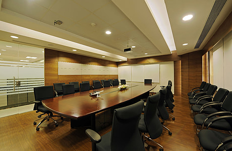 brown wooden conference table between chairs thumbnail