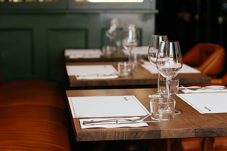 Clear Long-stemmed Wine Glass on Brown Table thumbnail